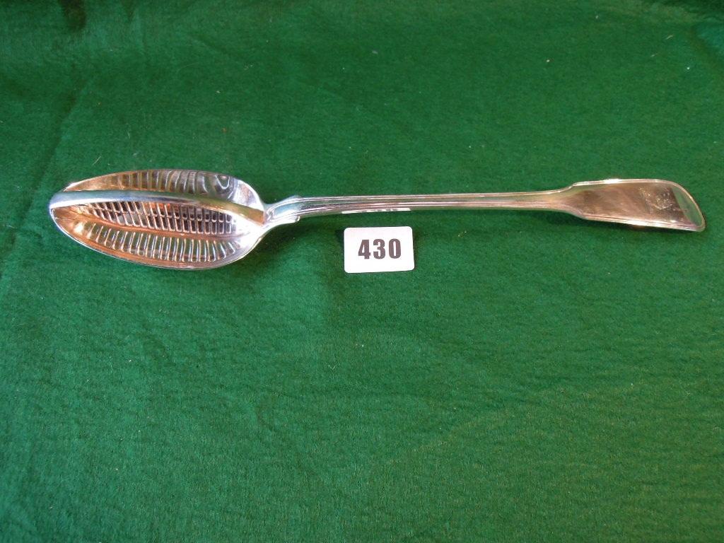 Appraisal: A George III silver gravy strainer with slatted central grill