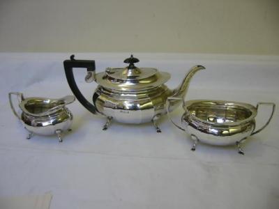 Appraisal: A THREE PIECE TEA SET of panelled bombe form with