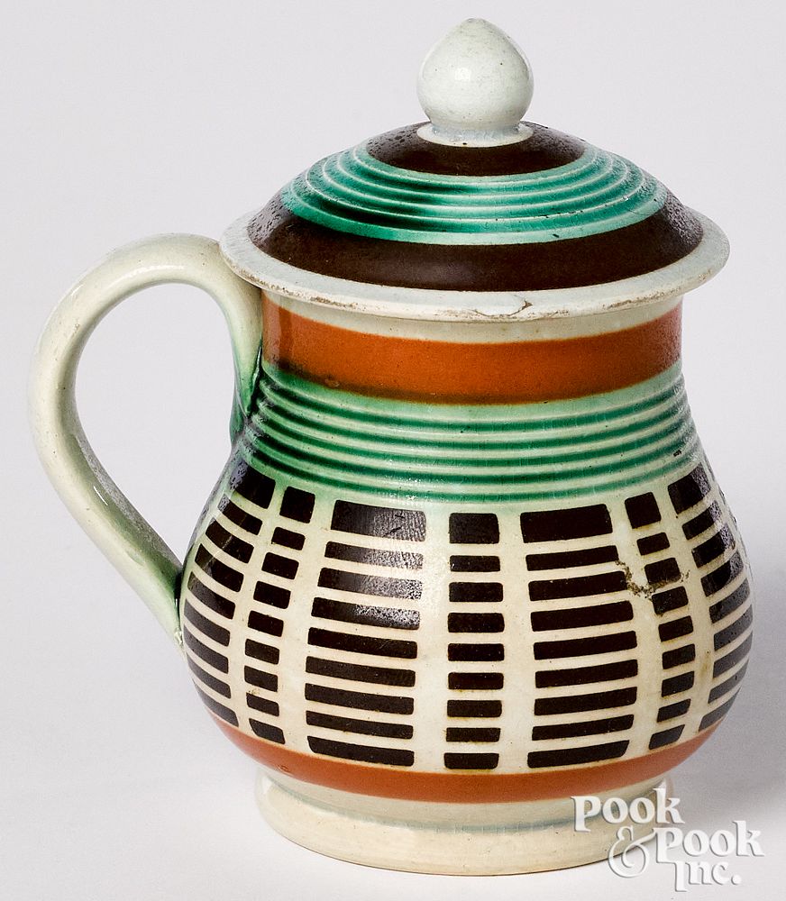 Appraisal: Mocha mustard pot Mocha mustard pot with engine turned decoration