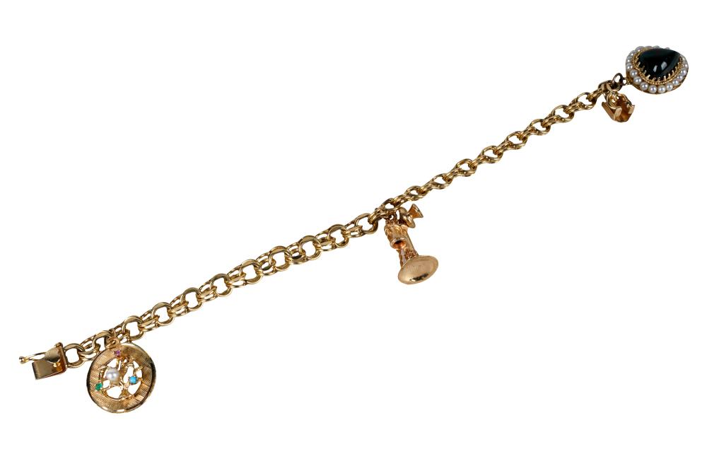 Appraisal: KARAT YELLOW GOLD CHARM BRACELETcontaining a karat yellow gold family