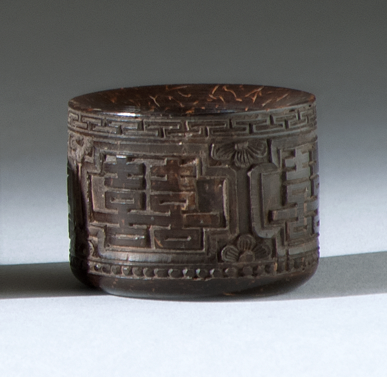 Appraisal: CASED COCONUT SHELL THUMB RING th CenturyIn double shou design