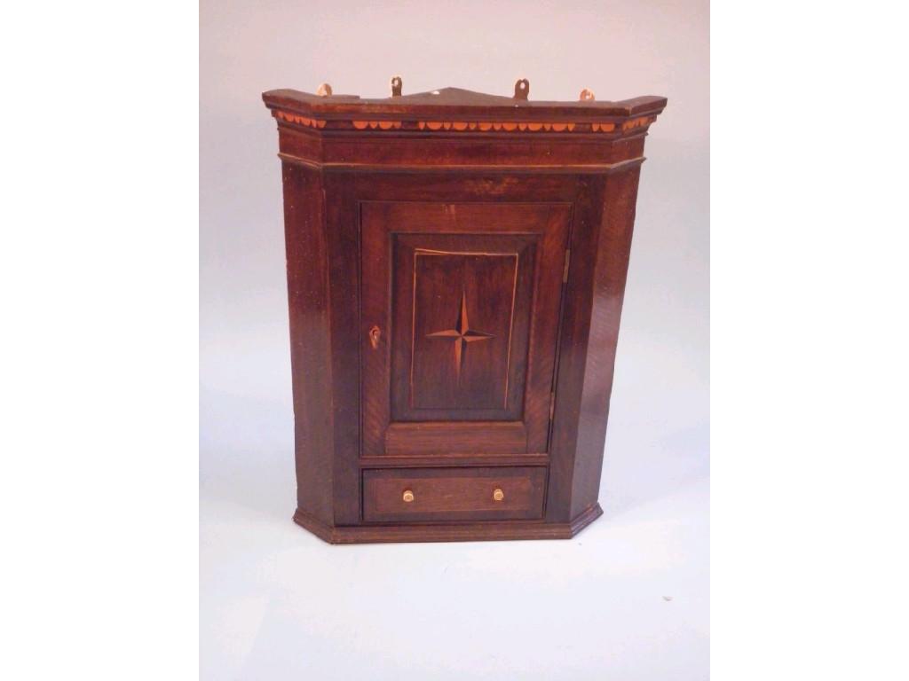 Appraisal: A small oak hanging corner cabinet with a carved border