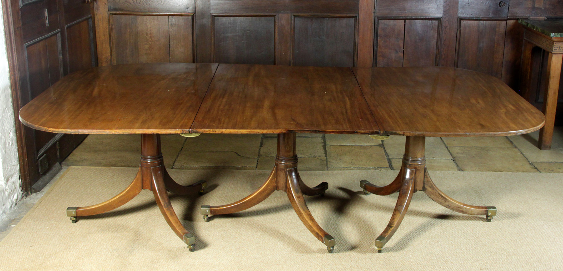 Appraisal: A George III mahogany three-pillar dining table the gun barrel