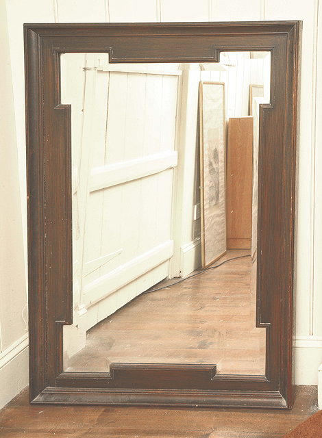 Appraisal: AN OAK FRAMED WALL MIRROR with shaped bevelled mirror plate