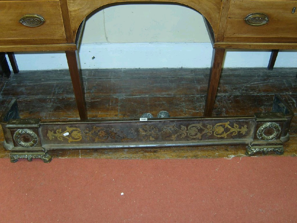 Appraisal: A Georgian mixed metal fender with floral frieze and relief