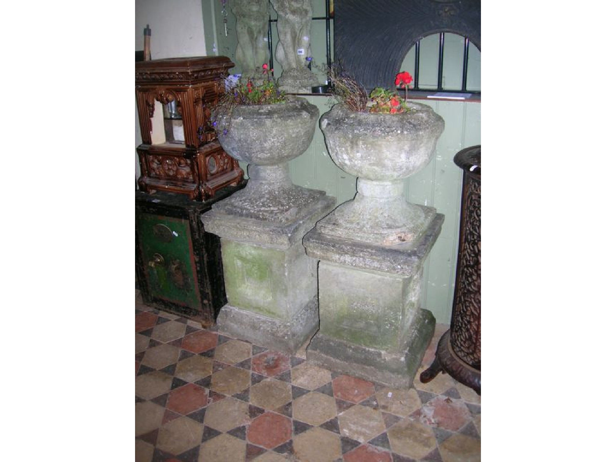 Appraisal: A pair of weathered cast composition stone garden urns the