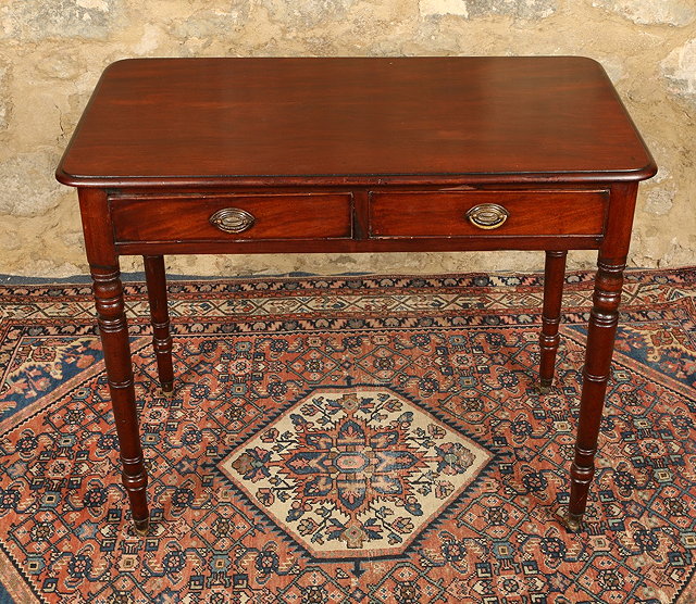 Appraisal: A REGENCY MAHOGANY WRITING TABLE fitted two drawers with opposed