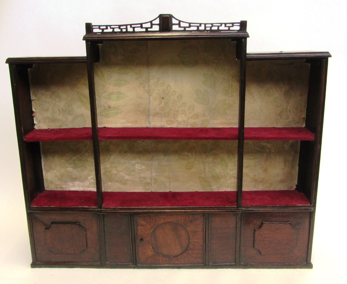 Appraisal: A th century mahogany hanging wall shelf in the form