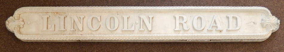 Appraisal: An unusual cream painted cast iron street sign with beaded