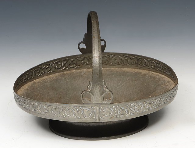 Appraisal: A TUDRIC PEWTER BEATEN OVAL BASKET the border with clover