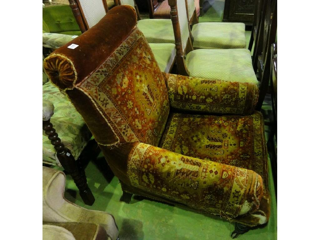 Appraisal: A late Victorian armchair with carpet upholstery and rolled head