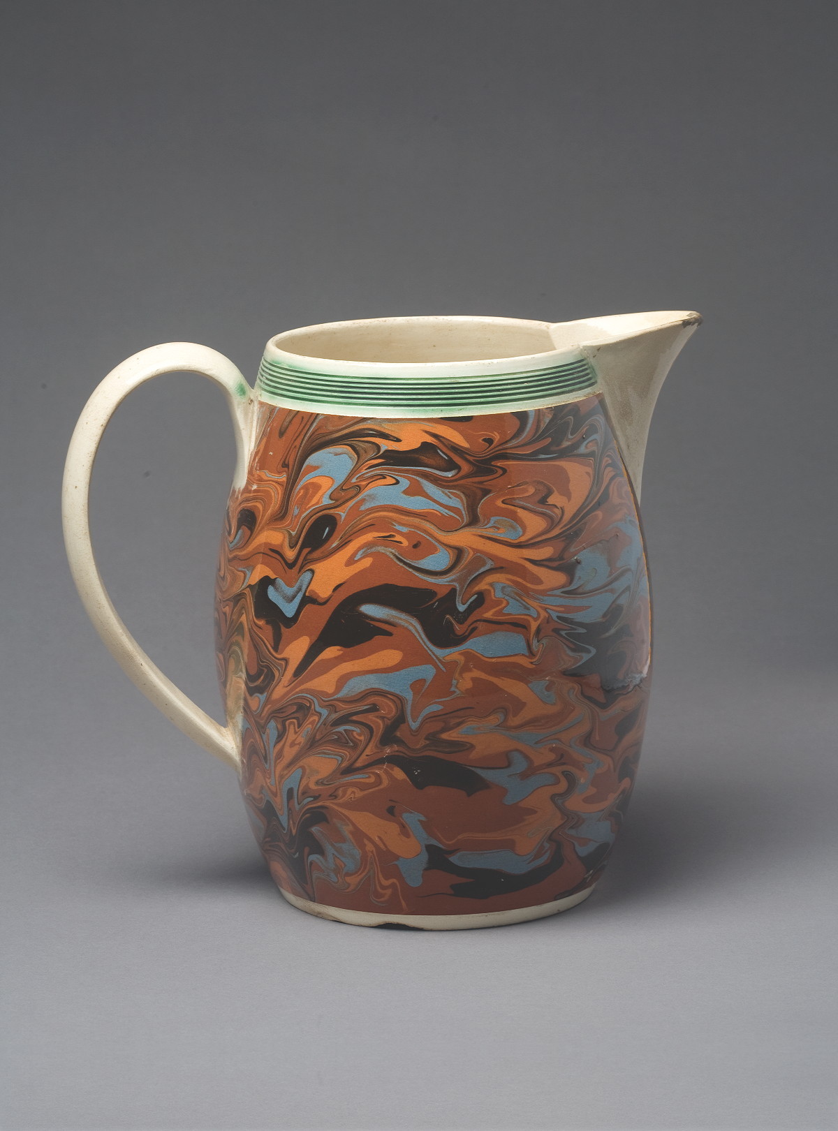 Appraisal: BRITISH PEARLWARE MOCHAWARE JUG CIRCA Of barrel form slip-marbled in