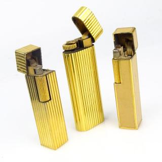 Appraisal: Three Vintage Cartier Gold Plate Butane Cigarette Lighters One with