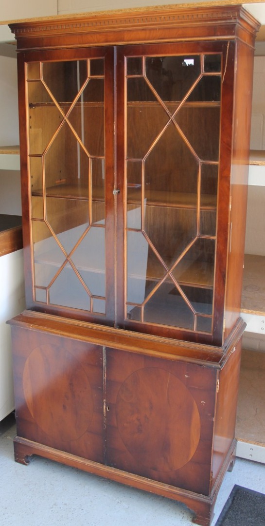 Appraisal: A thC yew wood finish display cabinet the upper section