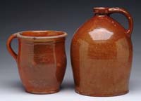 Appraisal: TWO PIECES OF GLAZED REDWARE An high orange red glazed