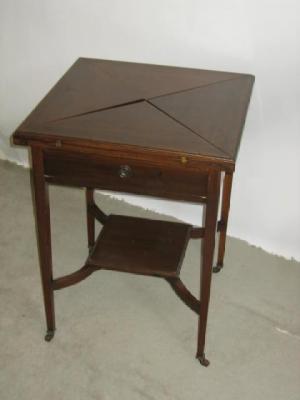 Appraisal: A MAHOGANY ENVELOPE TOP CARD TABLE with green baize lining