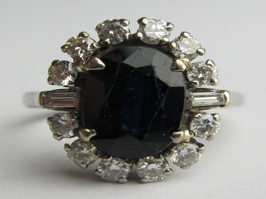 Appraisal: Eighteen carat white gold sapphire and diamond cluster ring with