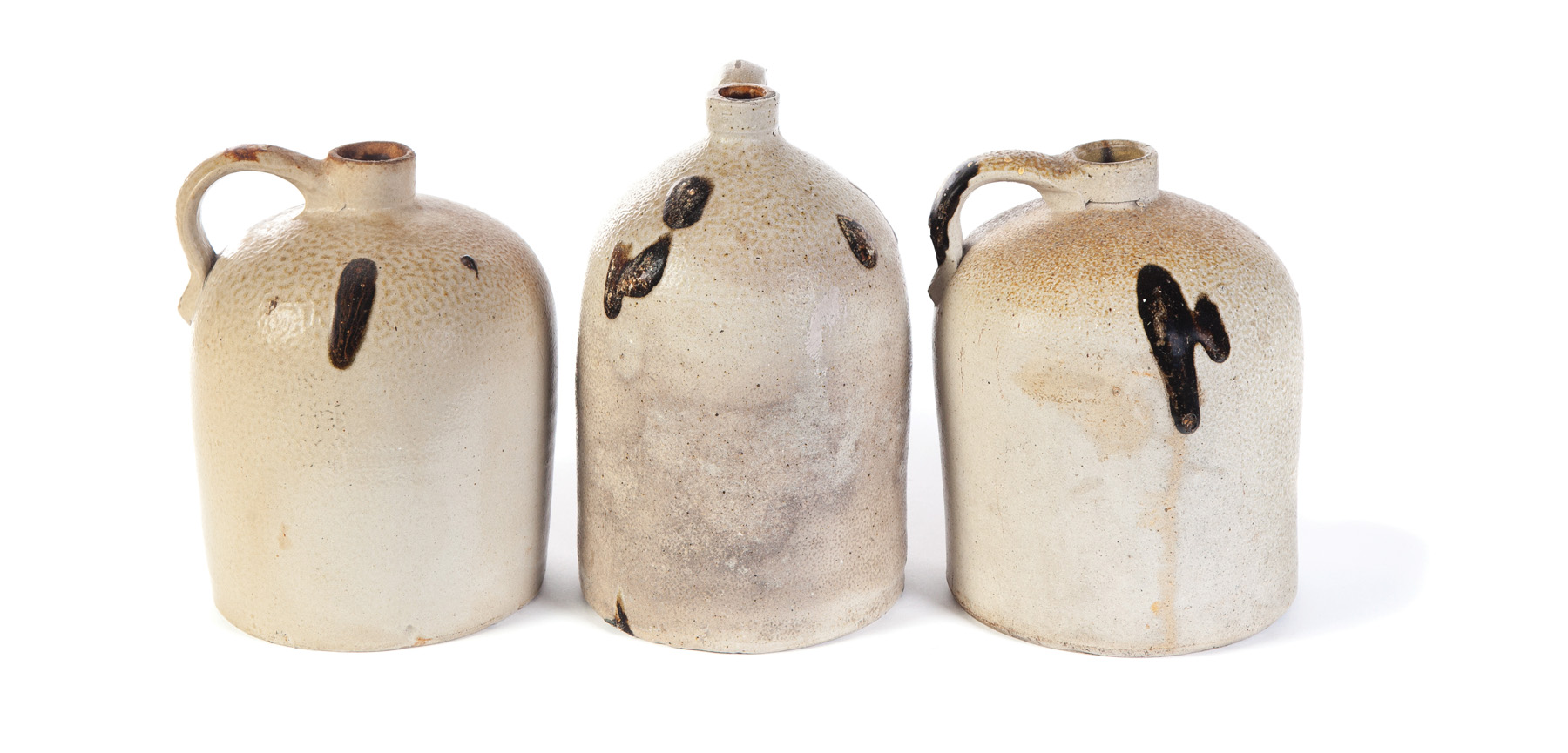 Appraisal: THREE STONEWARE JUGS WITH TOBACCO SPIT DECORATION American nd half-