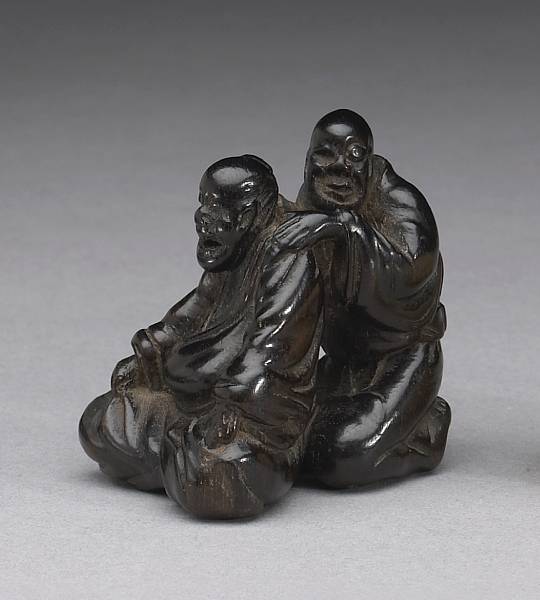 Appraisal: A black wood figural netsuke th Century Carved as a