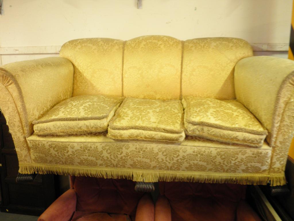 Appraisal: A sofa upholstered in gold fabric on carved feet