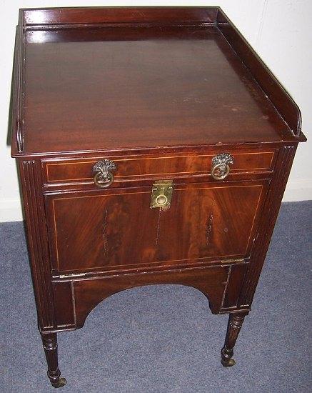 Appraisal: A th Century mahogany and inlaid pot cupboard the three-quarter