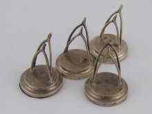 Appraisal: A set of four wishbone shaped silver menu holders George