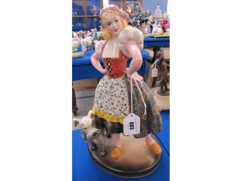 Appraisal: Pottery figure of a Dutch girl with a dog signed