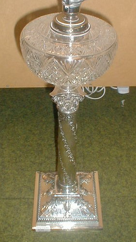 Appraisal: An Edwardian silver oil lamp converted for electricity embossed with