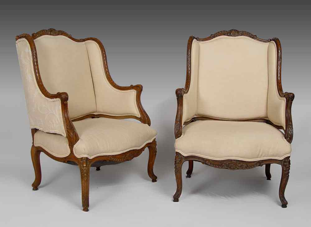 Appraisal: PAIR OF CARVED WALNUT WING BACK CHAIRS Nicely carved frame