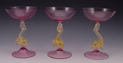 Appraisal: VENETIAN GLASS DOLPHIN BASE GLASSES Large cranberry glass bowls and