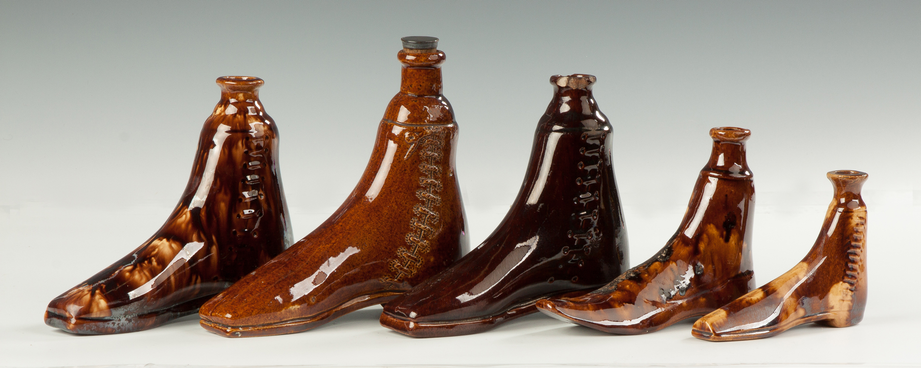 Appraisal: Collection of Rockingham Boot Flasks th cent L to R