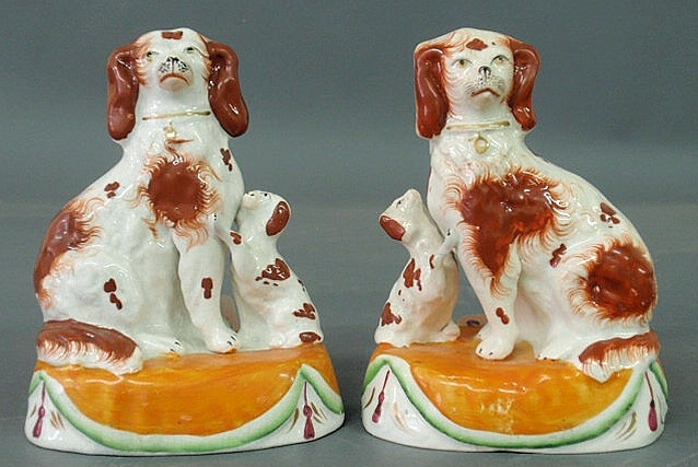 Appraisal: Pair of Staffordshire red and white spaniels with puppies sitting