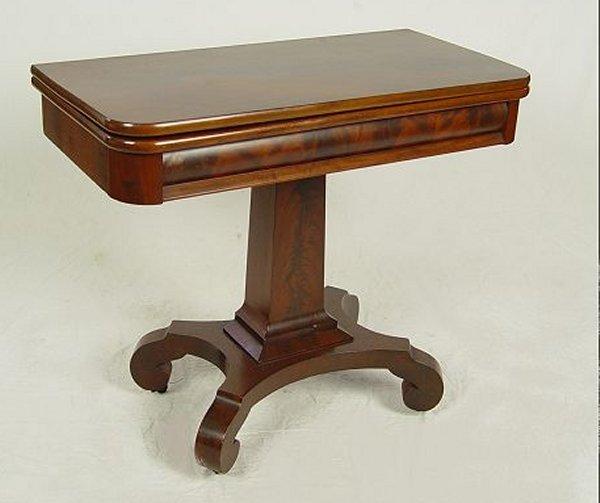 Appraisal: AMERICAN EMPIRE CROTCH GRAIN MAHOGANY GAME TABLE Pedestal base scroll