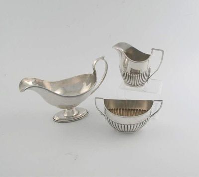 Appraisal: A modern sauceboat with reeded borders by S Blackensee Son