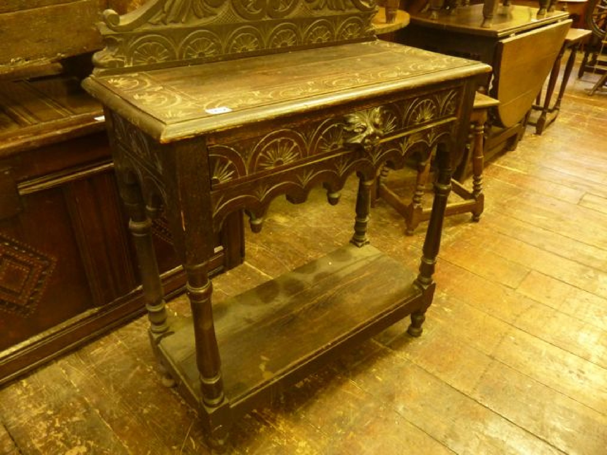 Appraisal: A Victorian carved oak two tier side table the raised