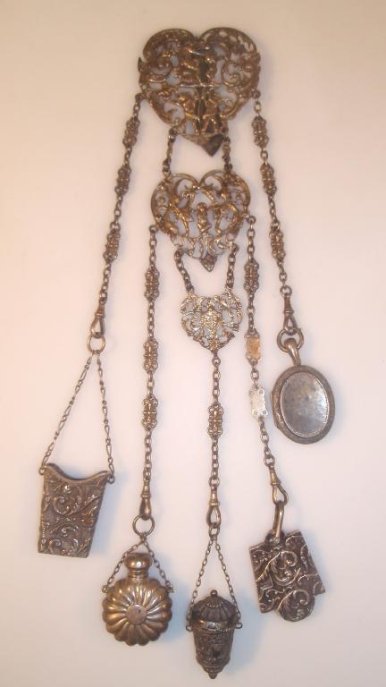 Appraisal: A Victorian silver chatelaine with locket aide memoire sal volatile