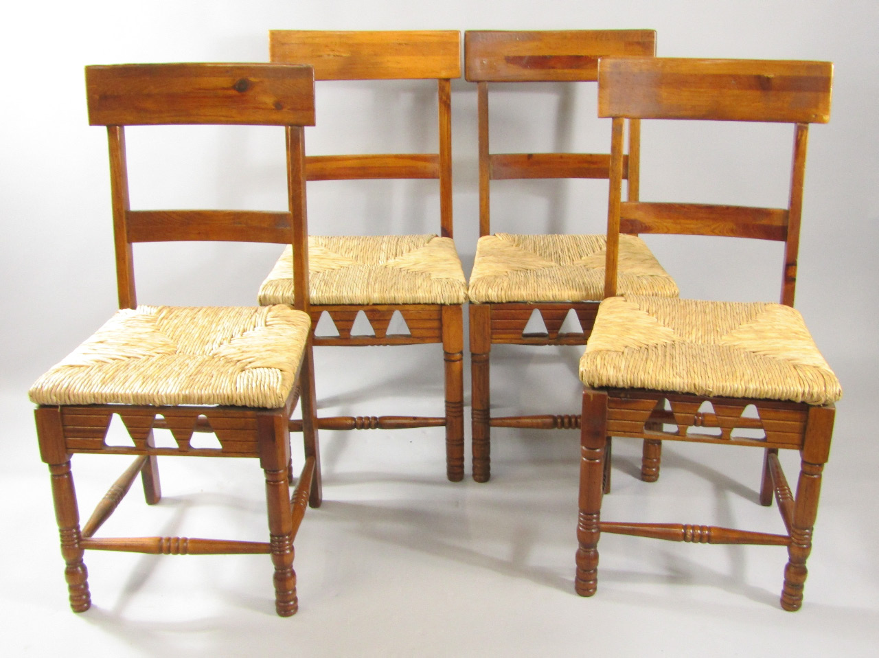 Appraisal: A set of four Dixy oak and rush seated single