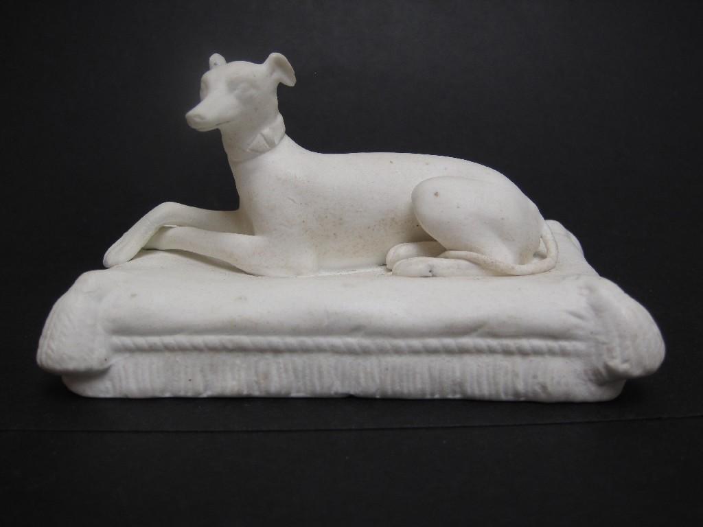 Appraisal: A bisque Figure of a seated whippet on cushion base