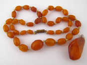 Appraisal: An amber bead necklace approx cm largest bead approx x