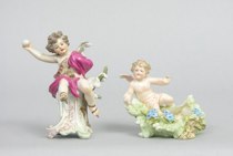 Appraisal: Two German Porcelain Cupid Figures Finely painted cupid wearing skates