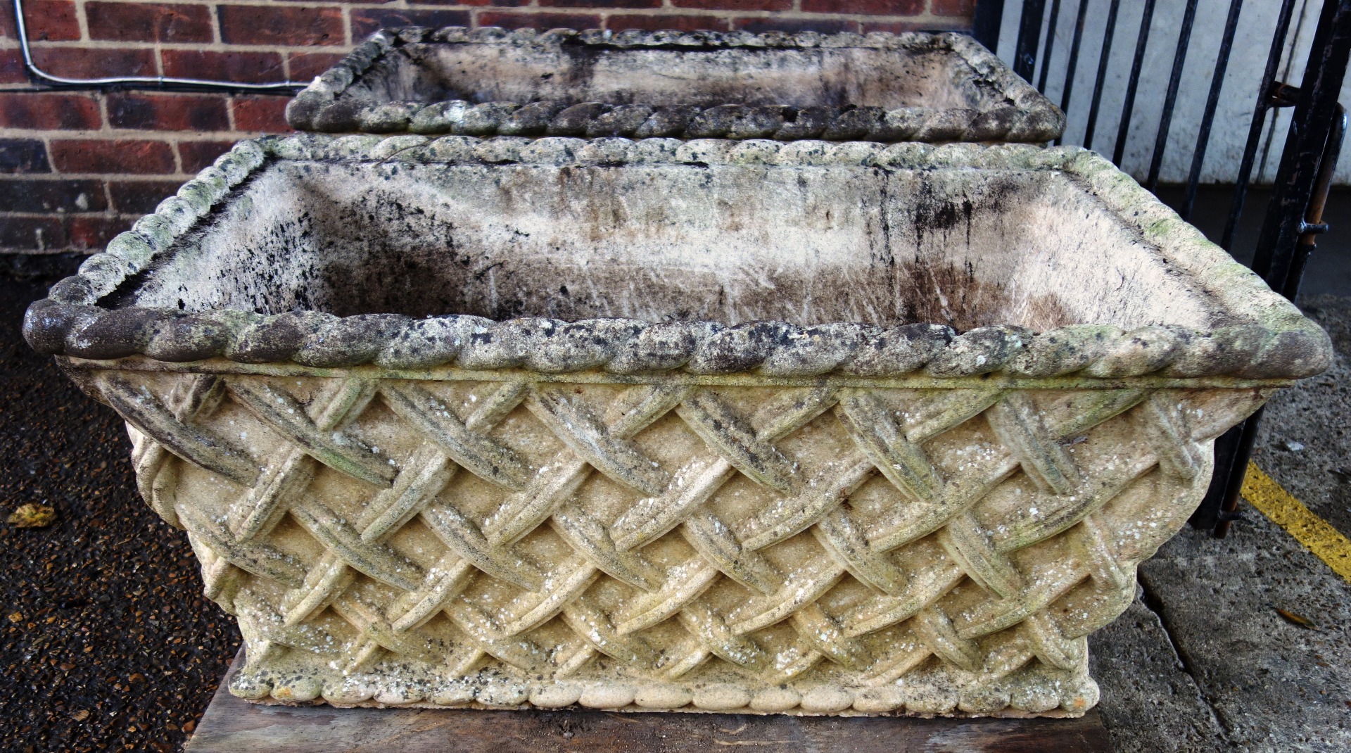 Appraisal: A pair of composite stone planters each with lattice work