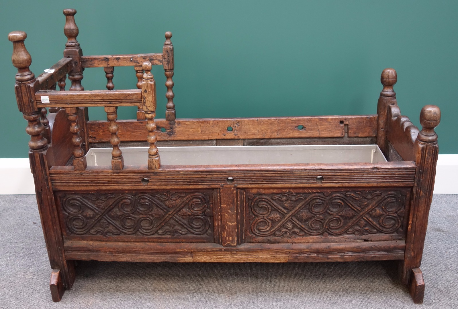 Appraisal: A th century carved oak cradle on turned supports cm