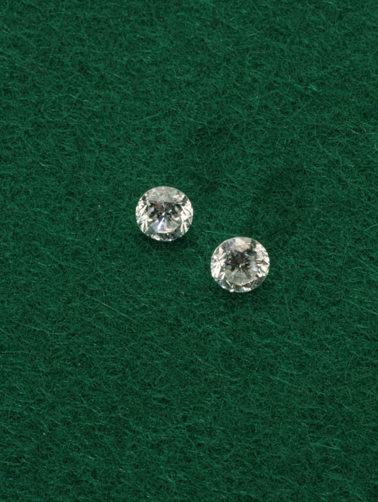 Appraisal: Two Unmounted Diamonds Each brilliant-cut the first weighing exactly carats