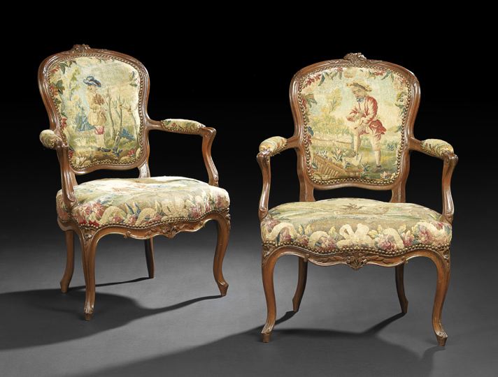 Appraisal: Pair of Provincial Louis XV-Style Fruitwood Fauteuils late th century