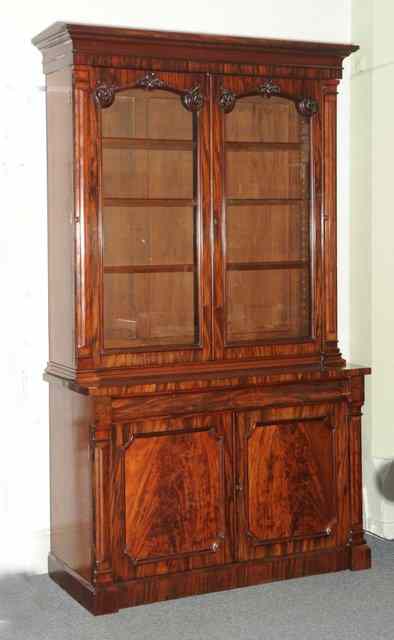 Appraisal: AN EARLY VICTORIAN MAHOGANY BOOKCASE with arch glazed cupboard doors