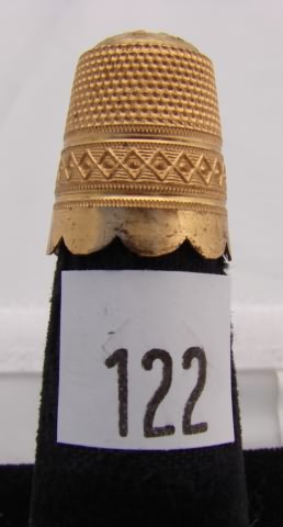 Appraisal: Gold tone thimble with folk design crimped band