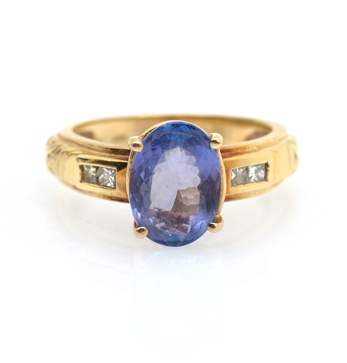 Appraisal: K TANZANITE DIAMOND RING K yellow gold ring contains one