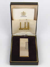 Appraisal: A boxed silver plated Dunhill cigarette lighter made in Switzerland