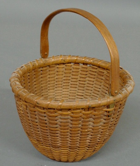 Appraisal: Delicate woven Nantucket Lightship basket th c with swing handle