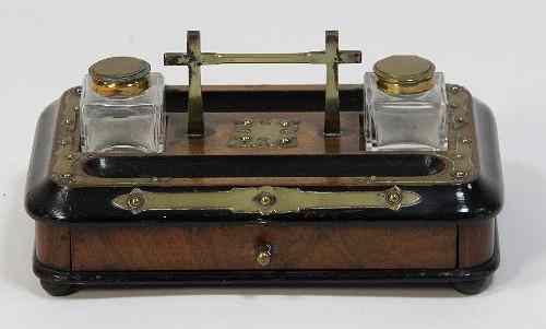 Appraisal: A Victorian walnut and ebonised ink stand with glass wells